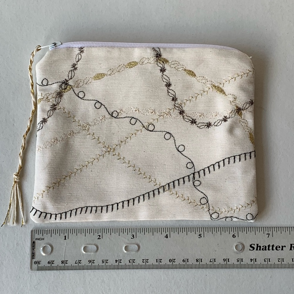 Cream colored metallic embroidered travel bag case
